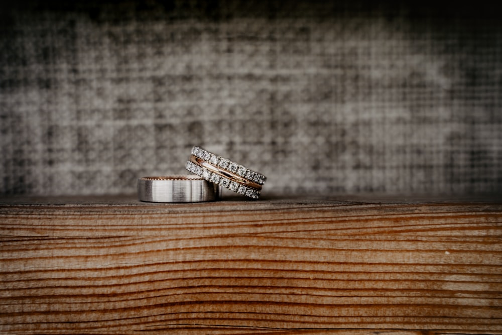 silver and black battery on brown wooden table