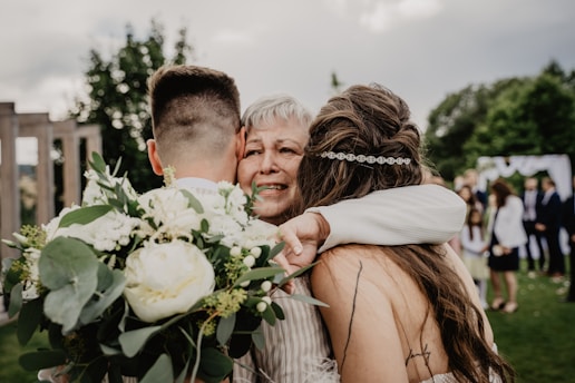 man and woman kissing on forehead during daytime