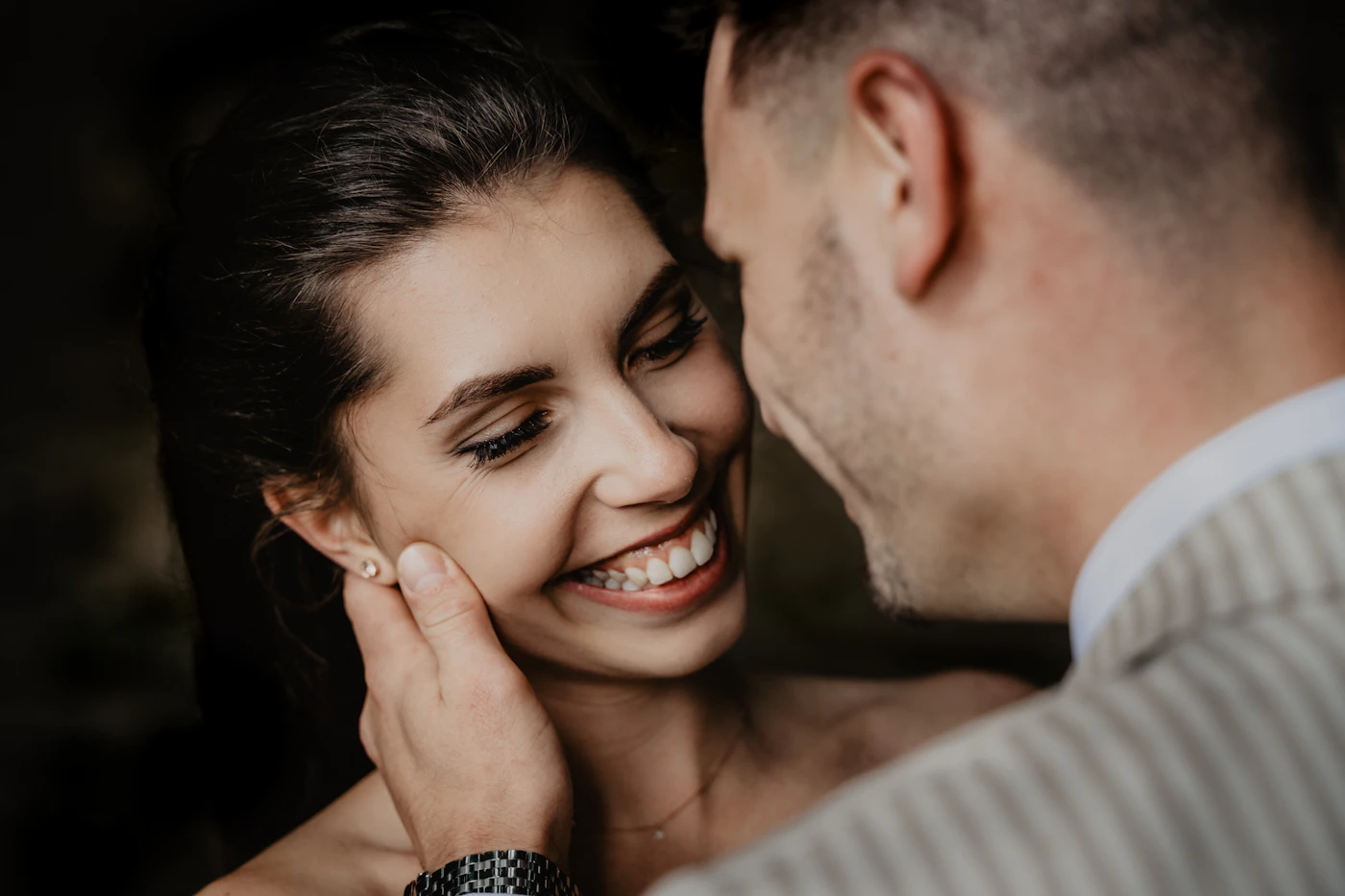 Bride and groom sharing a joyful kiss together outdoors