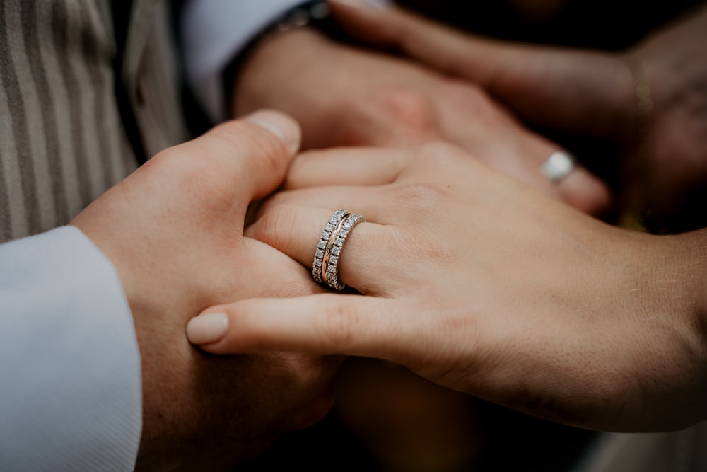 person wearing silver diamond ring