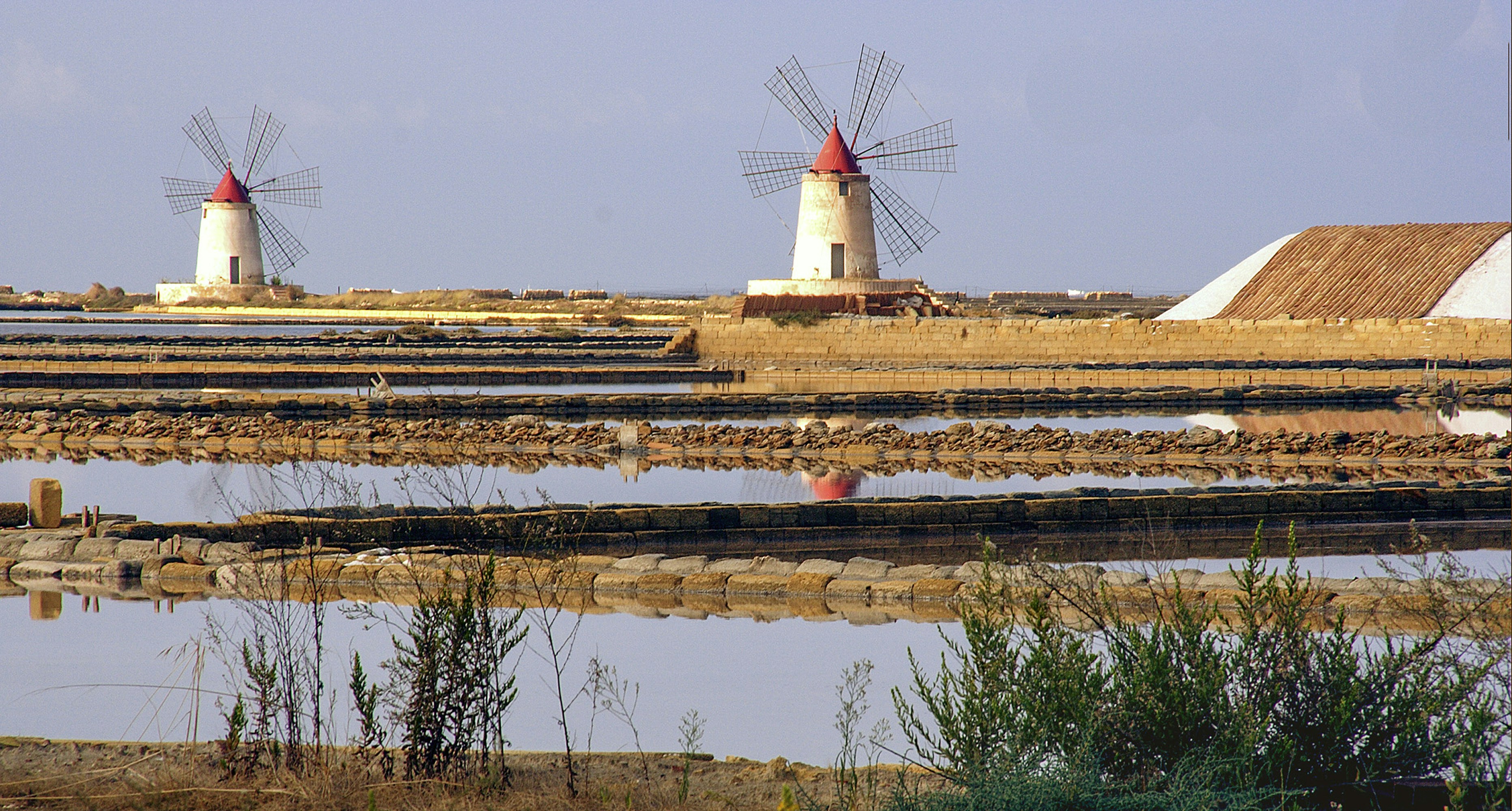 white and red lighthouse near body of water during daytime