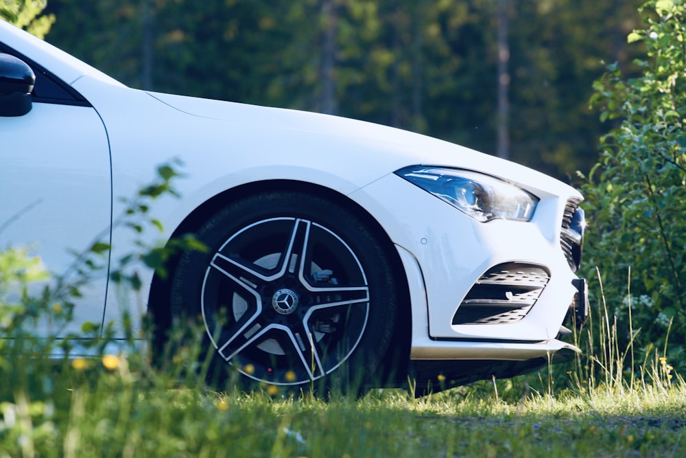 white bmw m 3 on green grass field during daytime