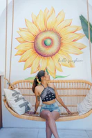 A sunlit porch swing with soft Sunbrella cushions surrounded by blooming flowers.
