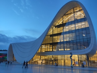 architectural photography,how to photograph baku azerbaijan; people walking on the street near the glass building during daytime