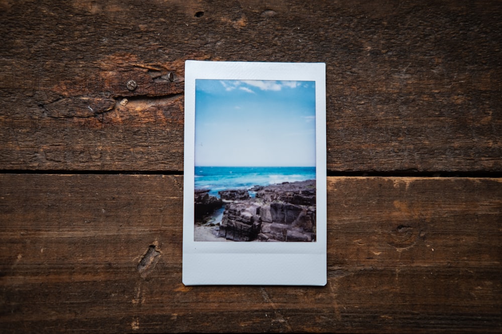 white and blue picture on brown wooden surface