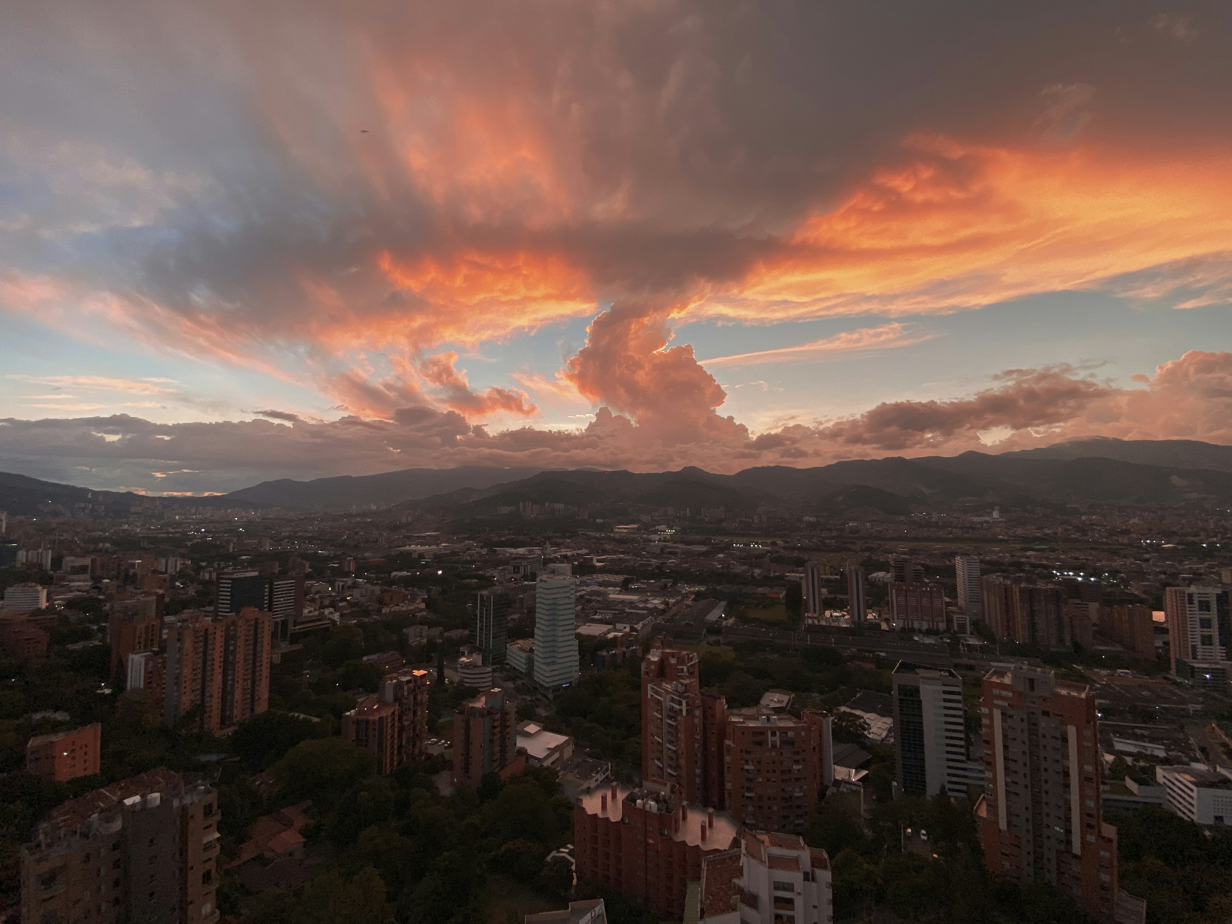 high rise buildings under white clouds during daytime