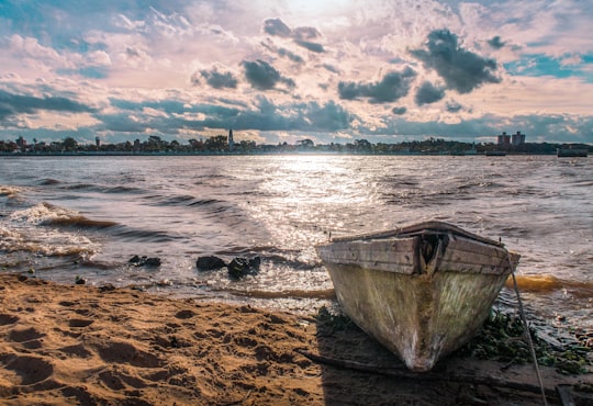 white boat on sea shore during daytime in Santa Fe Argentina