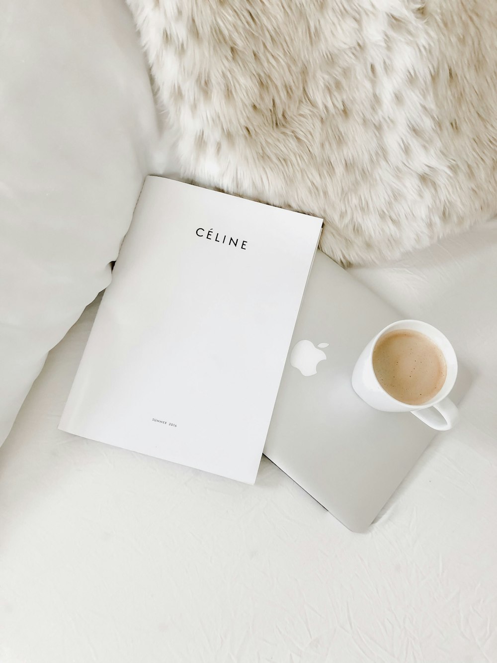 white ceramic mug beside white paper