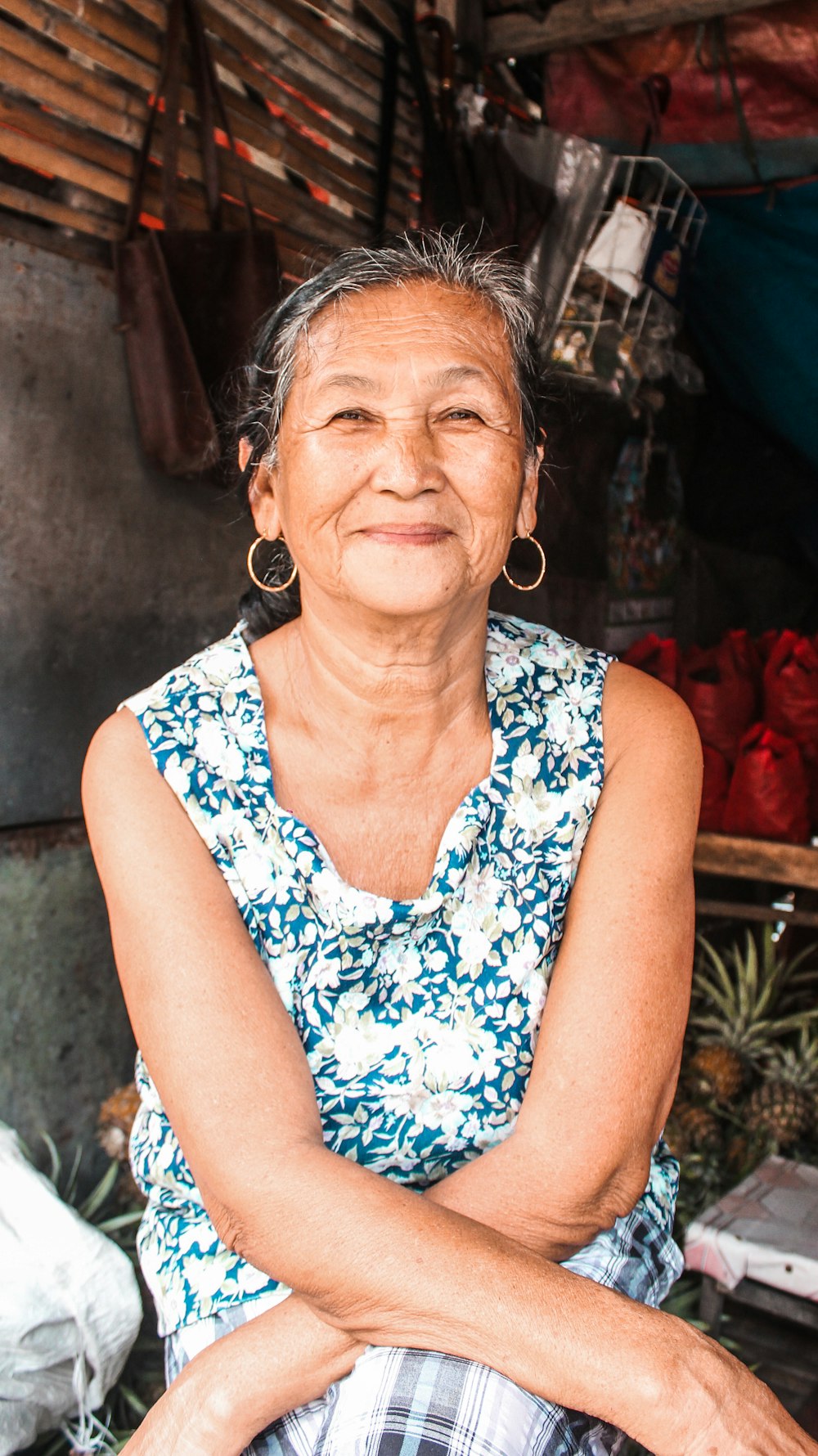 woman in blue and white floral sleeveless shirt wearing eyeglasses