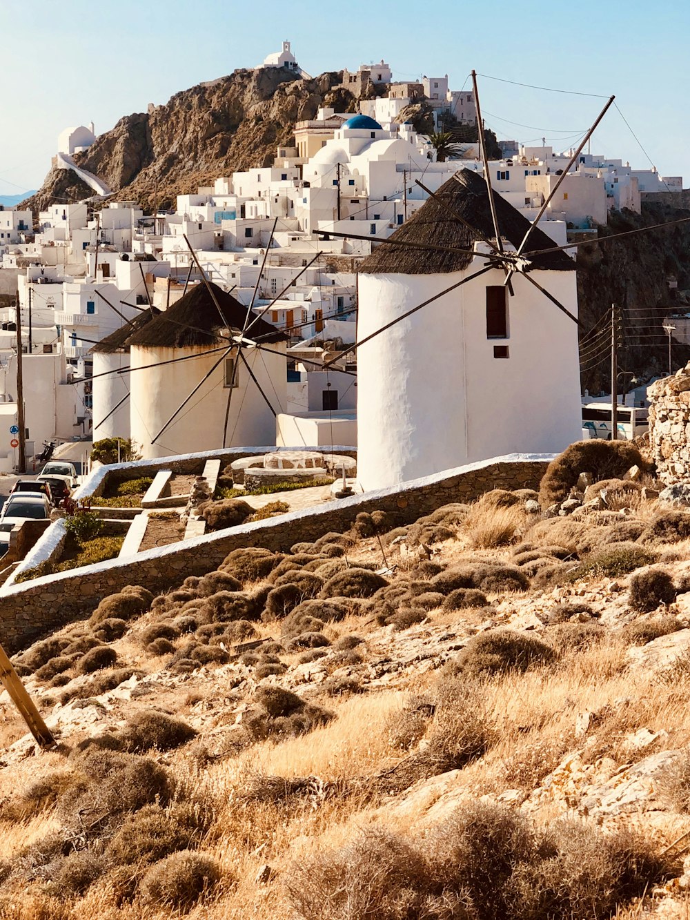 white concrete building near brown grass field during daytime