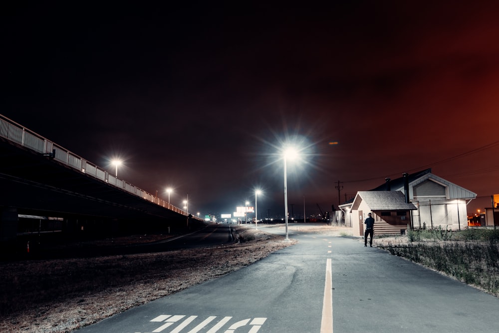 white and brown house beside road during night time