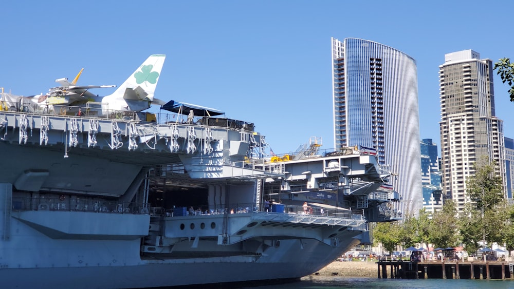 white and gray airplane on dock during daytime