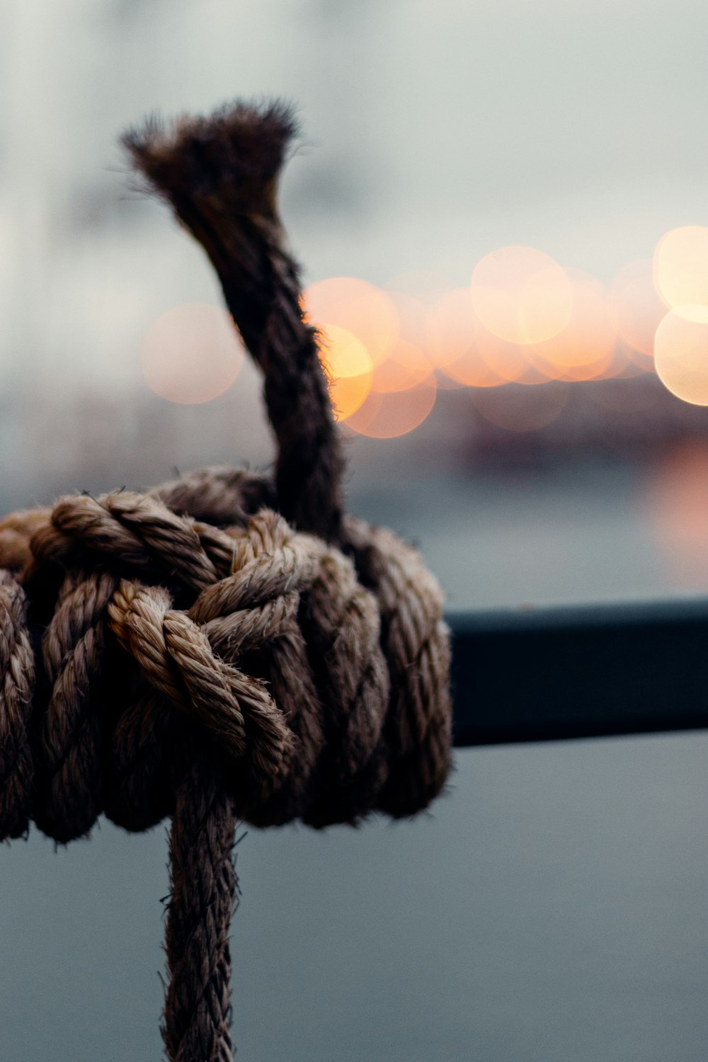 brown rope on black wooden fence