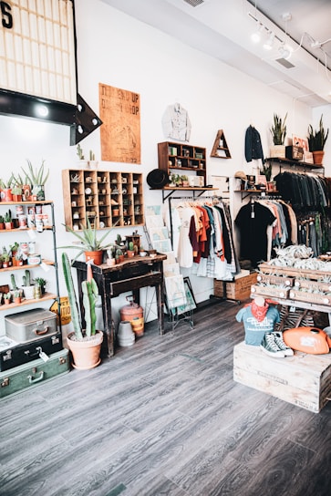A cozy thrift shop interior filled with vintage clothing and decor.