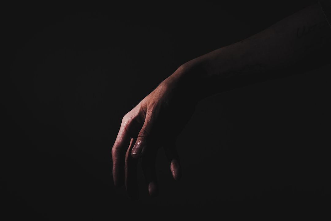 persons hand on black textile