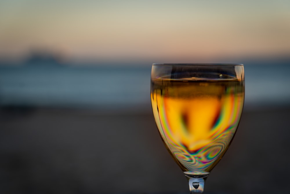 clear wine glass with yellow liquid