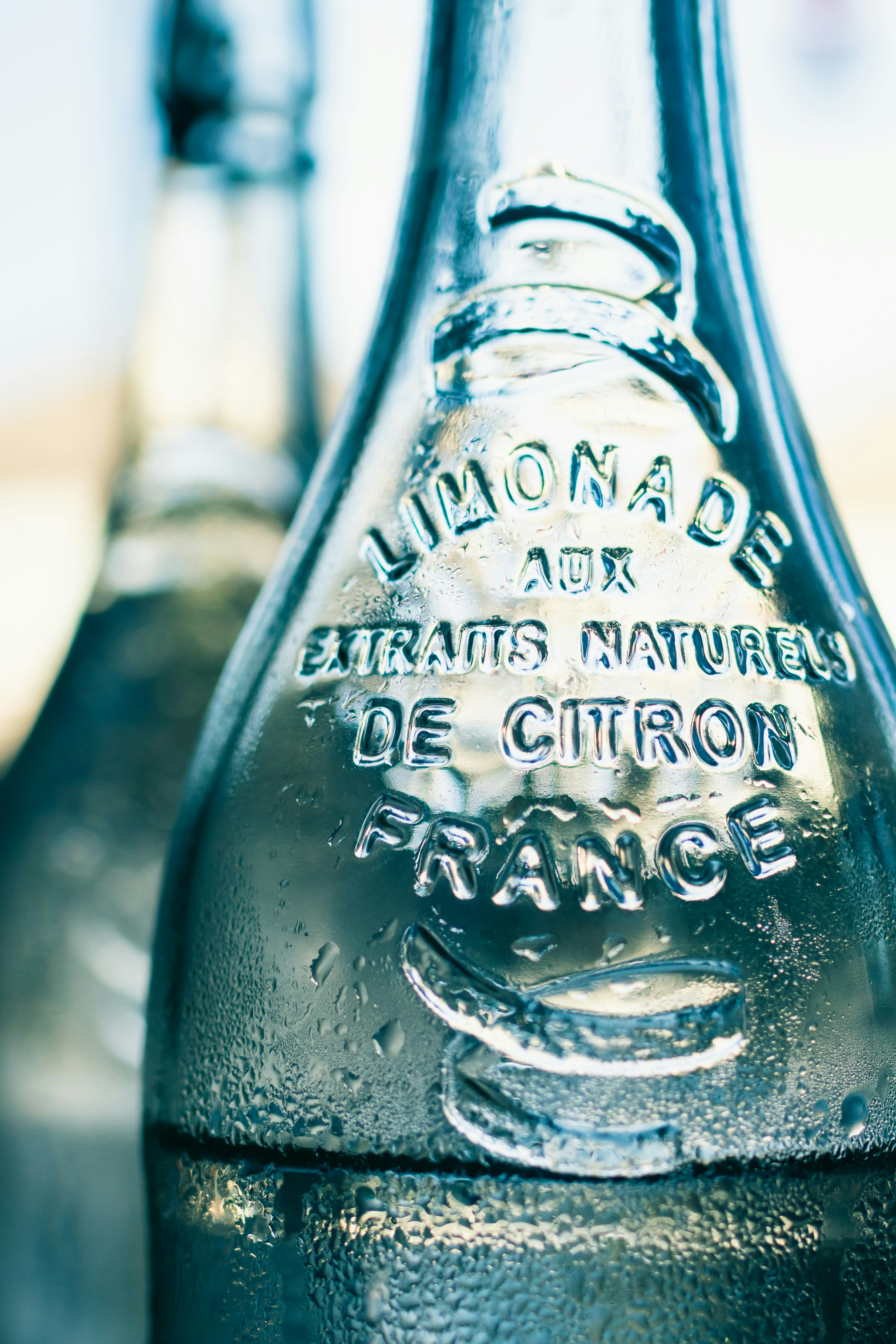 blue and white labeled bottle photo Free Drink Image on Unsplash