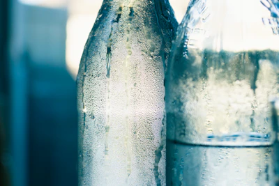 Close-up of chilled Venezuelan soda bottles glistening with condensation.