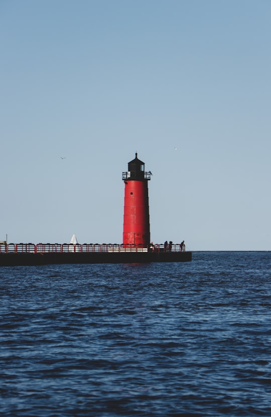 red and white lighthouse on sea during daytime in Milwaukee United States