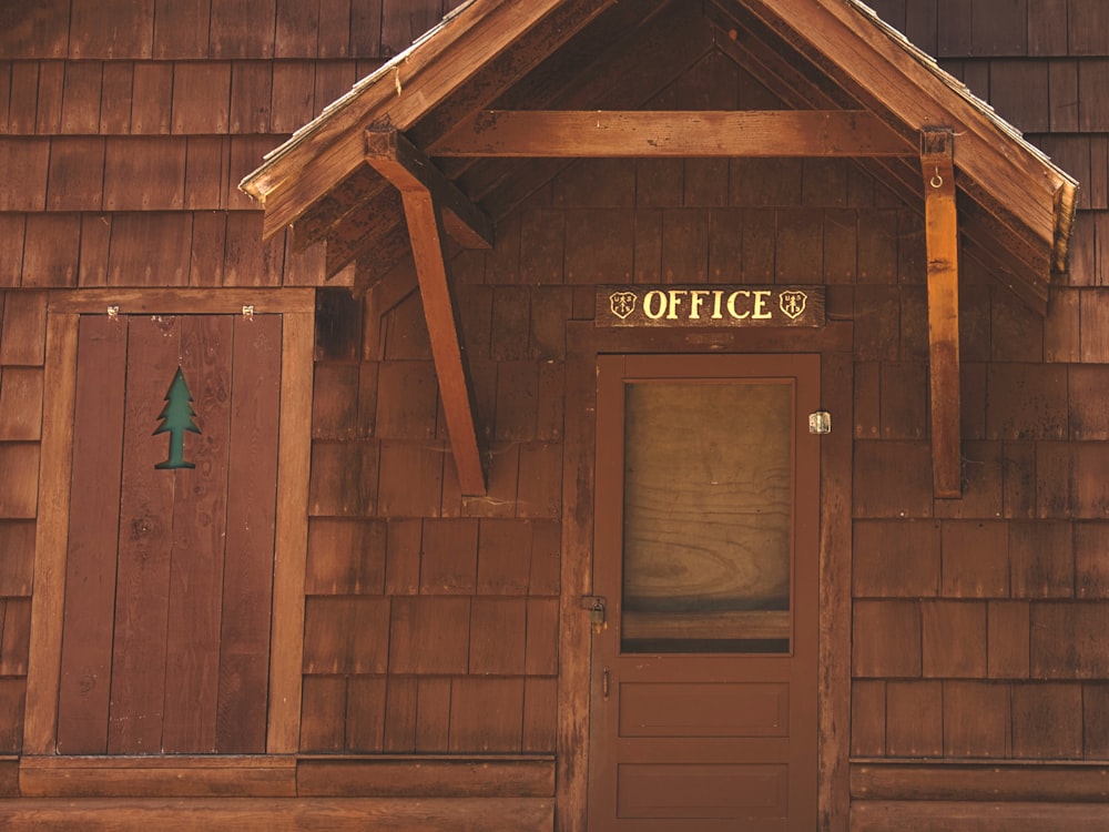 a wooden building with a sign on the front of it