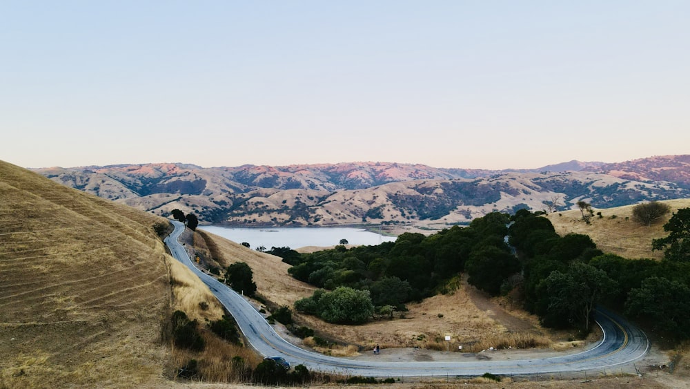 brown and green mountains near body of water during daytime