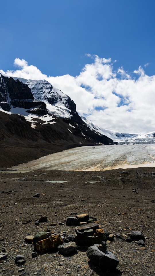 snow covered mountain under cloudy sky during daytime in Athabasca Glacier Canada