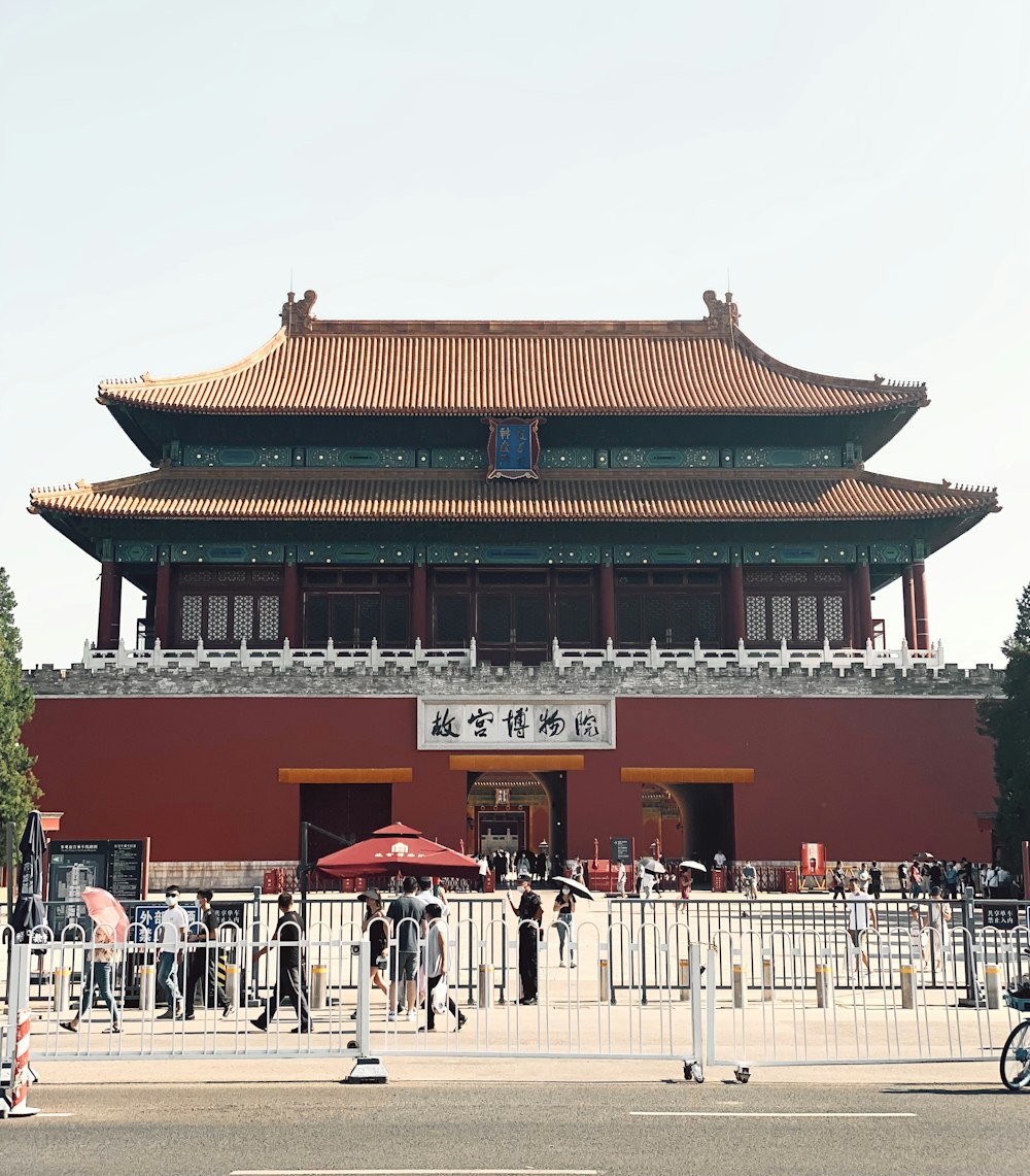 people walking on red and white temple during daytime