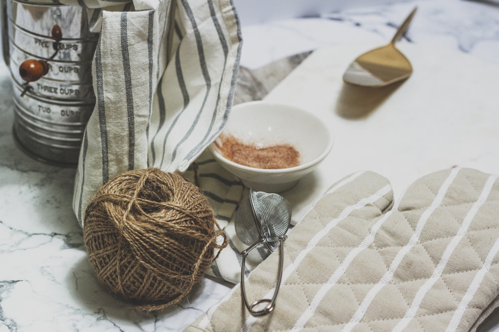 white ceramic bowl on white table cloth