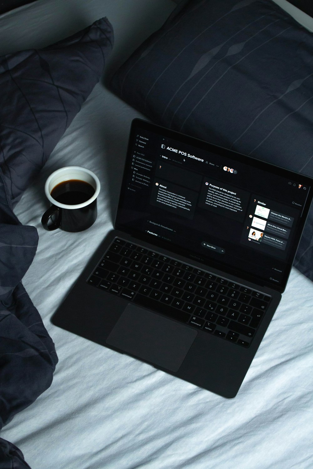 black laptop computer on white textile