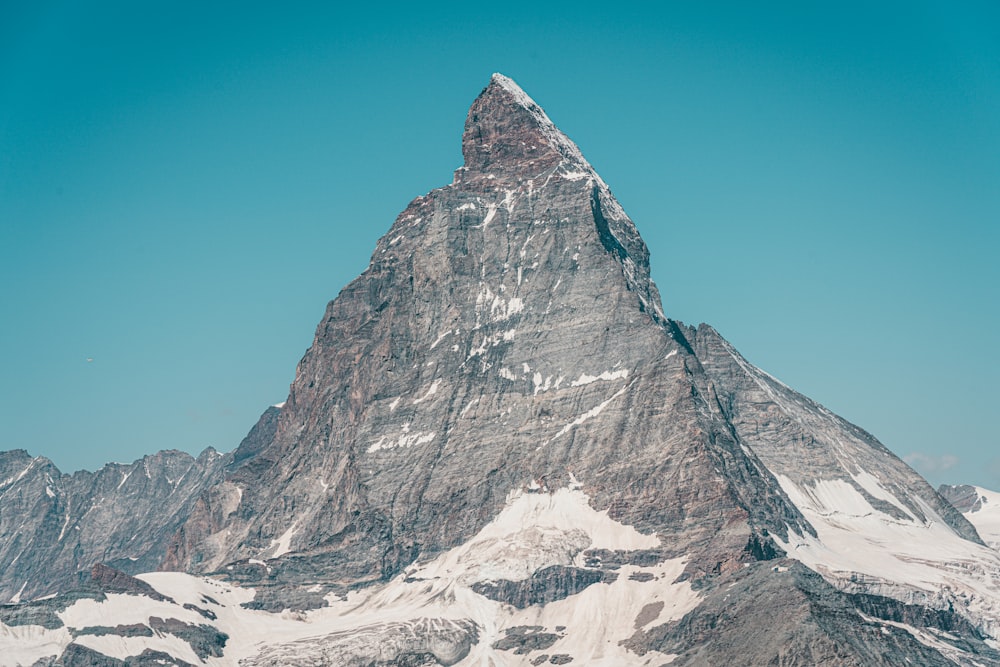 gray rocky mountain under blue sky during daytime