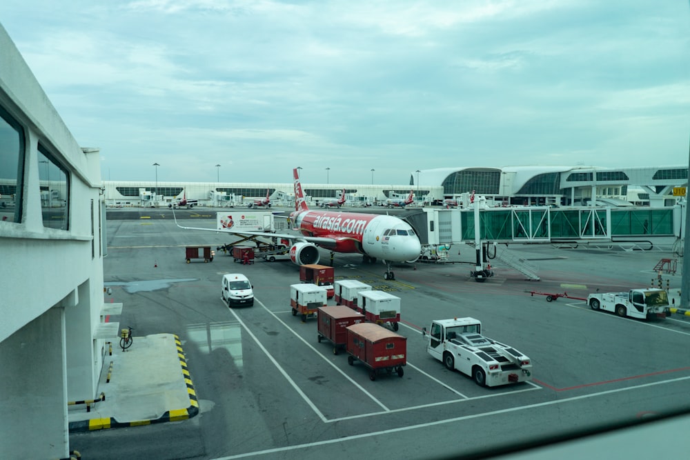 white and red passenger plane on airport during daytime