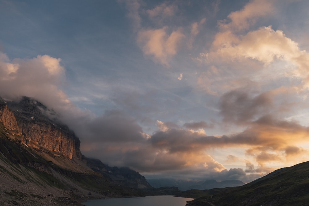 brown and green mountains under white clouds