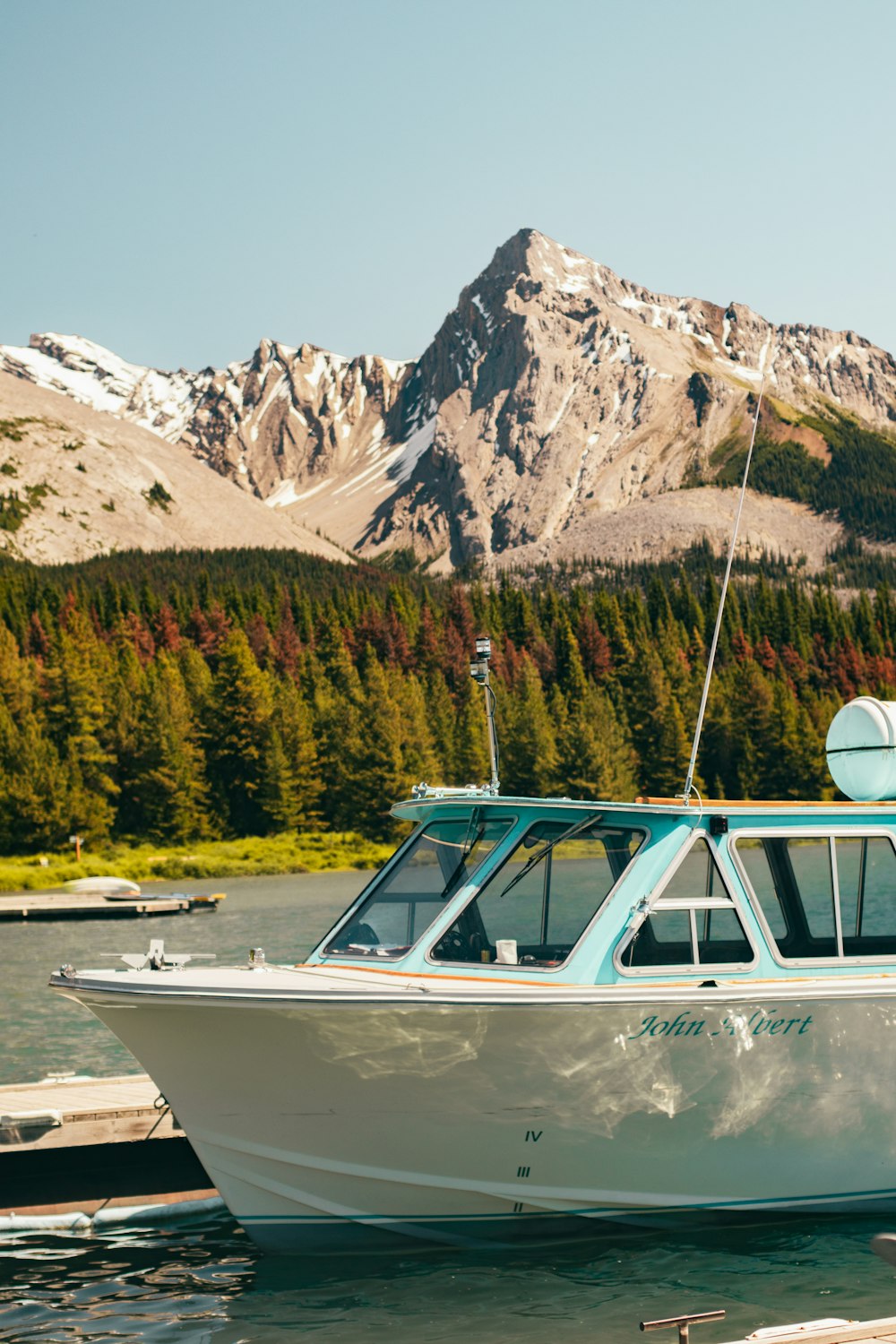 white and blue boat on lake during daytime