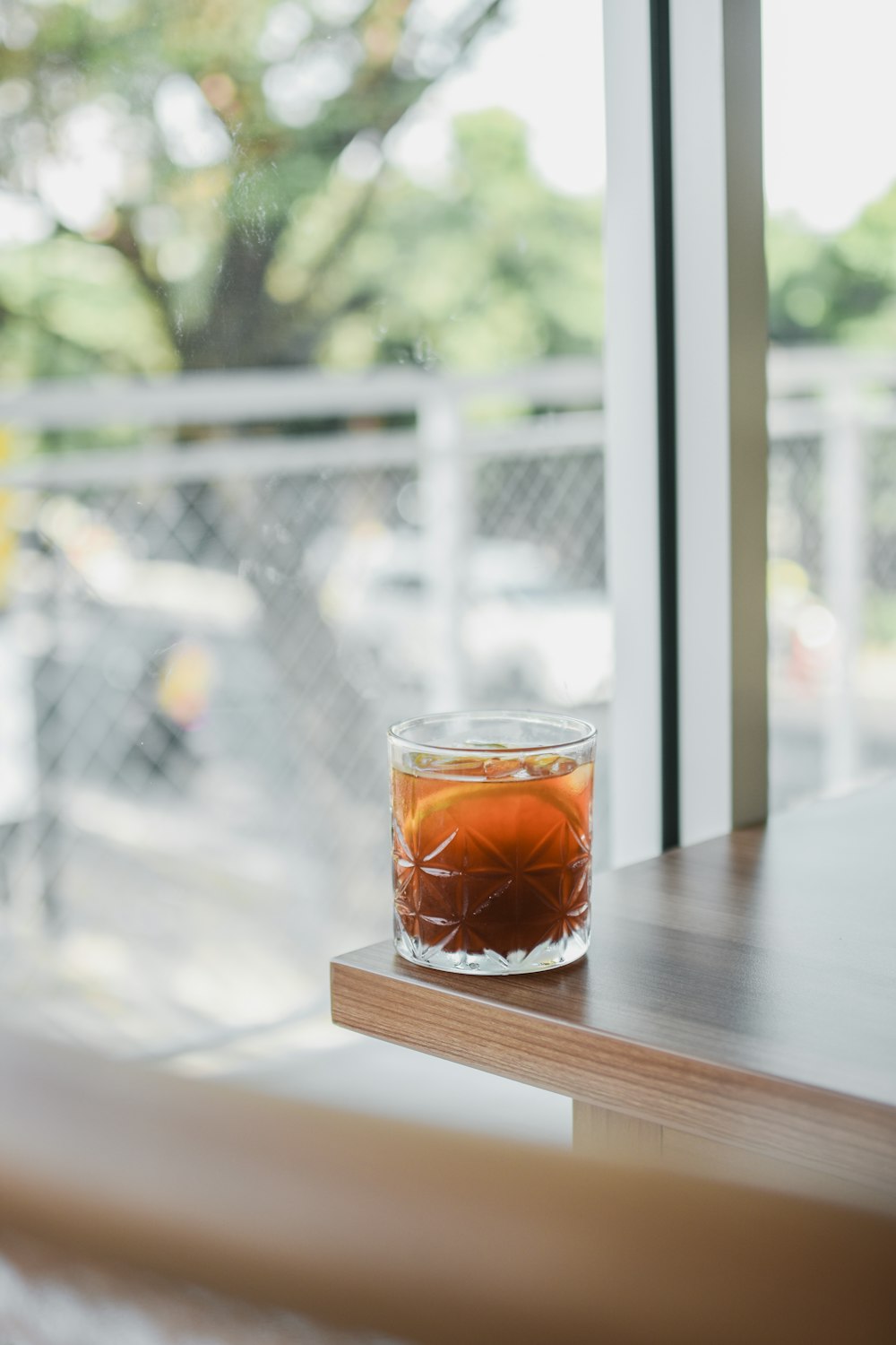 clear drinking glass with brown liquid inside