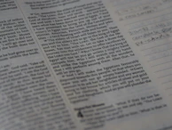 Close-up of ancient scriptures being carefully examined by curious hands.