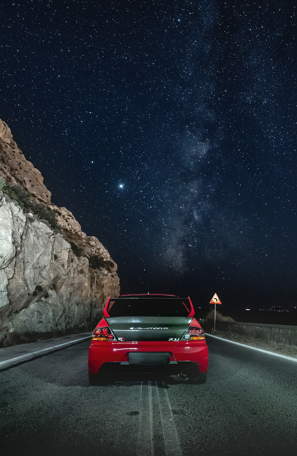 red car on road during night time