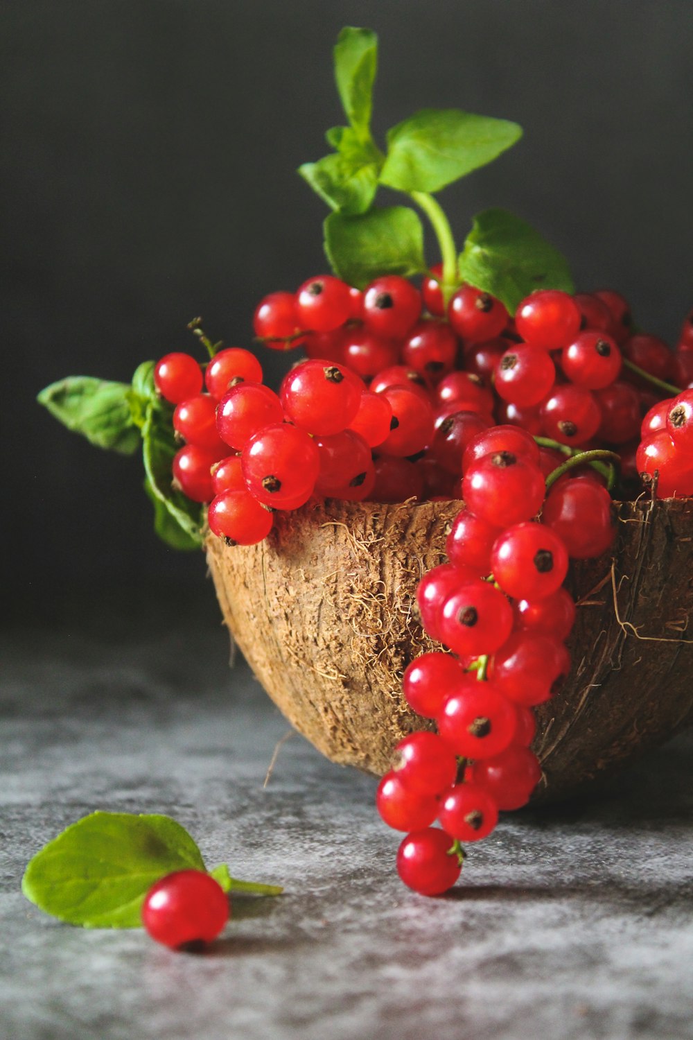 red cherries on brown wooden bowl