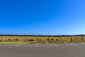 gray asphalt road under blue sky during daytime