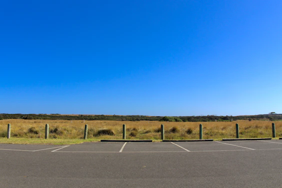 gray asphalt road under blue sky during daytime