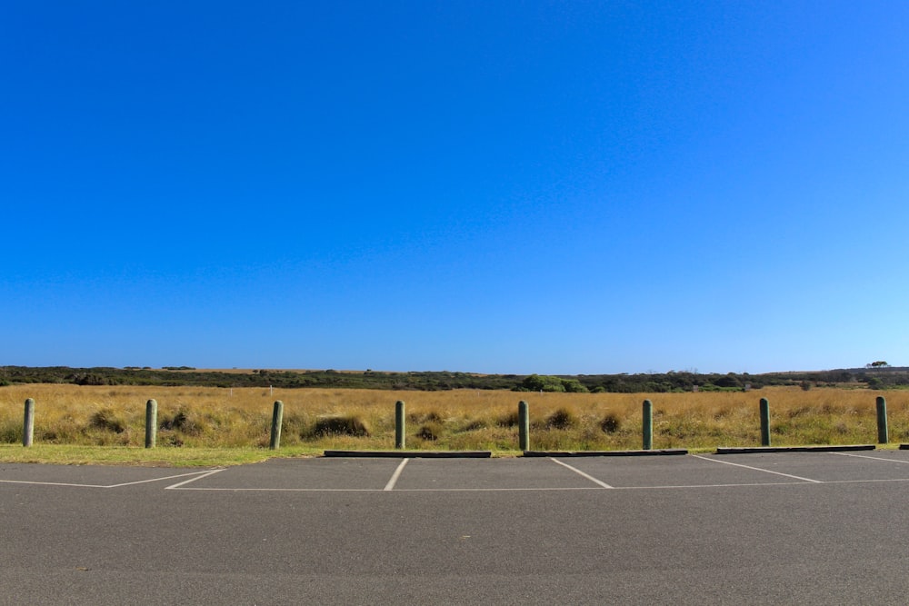 gray asphalt road under blue sky during daytime