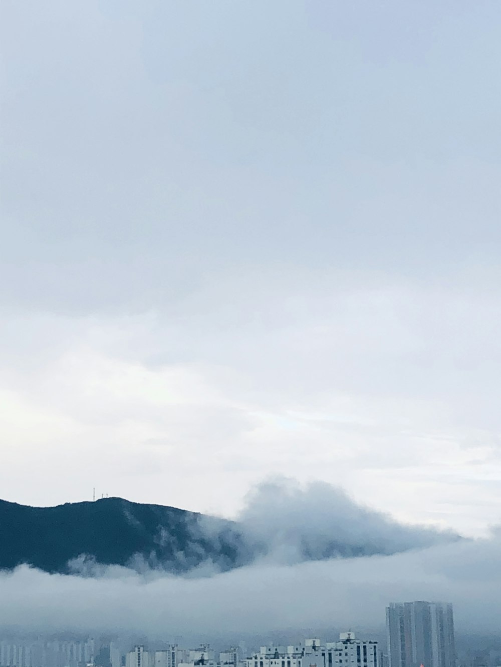 green mountain under white clouds