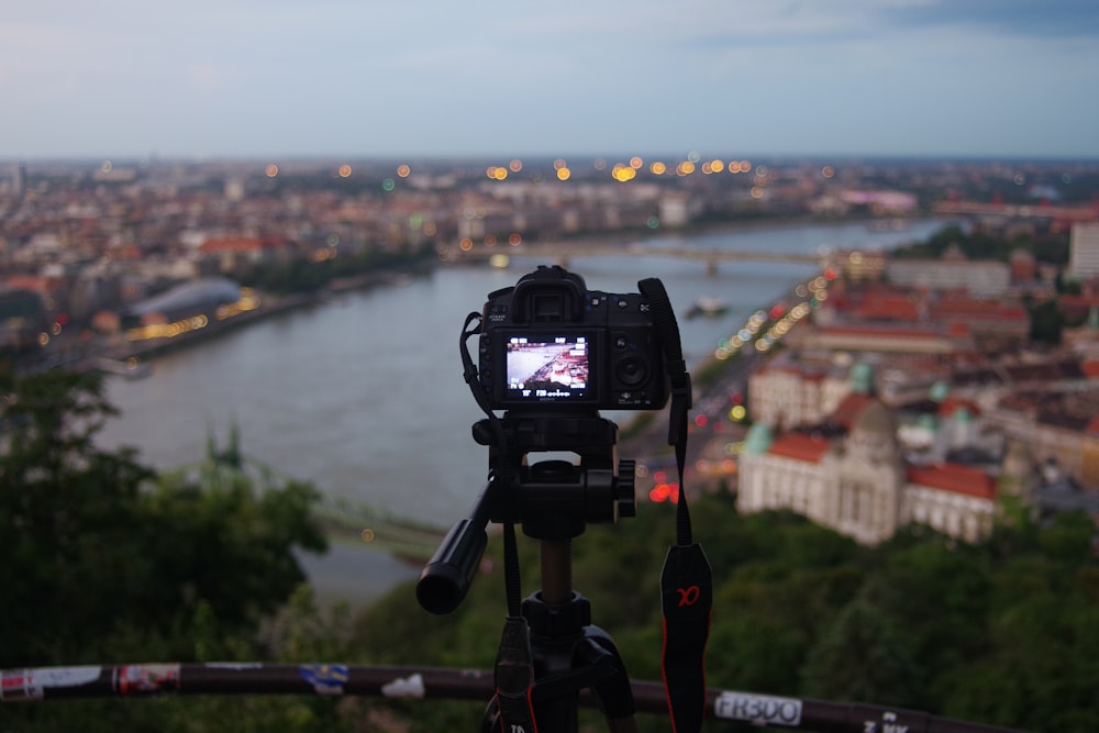 black dslr camera on tripod