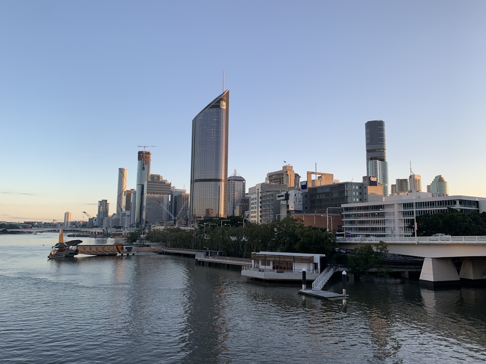 white boat on water near city buildings during daytime