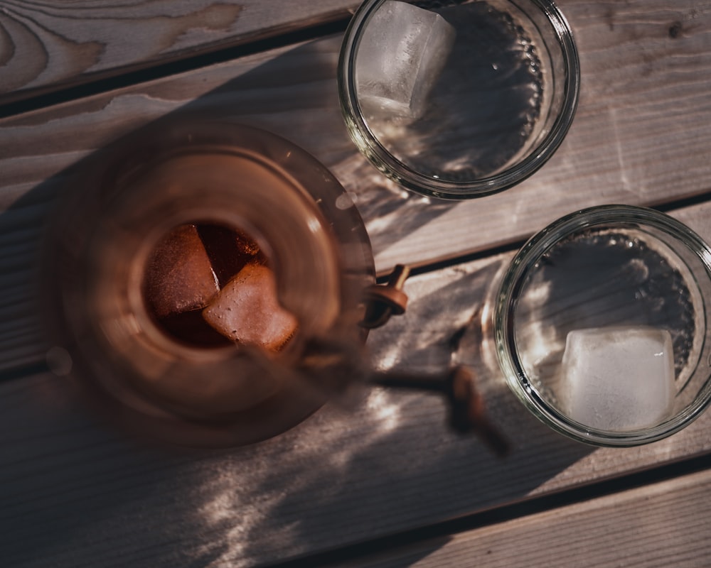 clear glass mug on brown wooden round tray