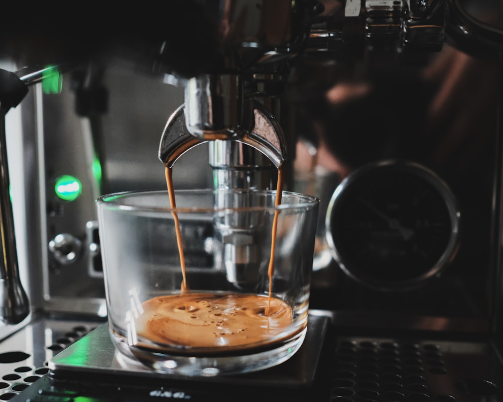 clear glass cup with brown liquid