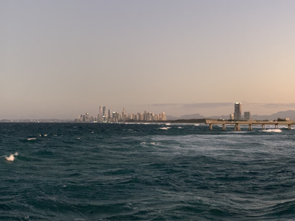 city skyline across body of water during daytime