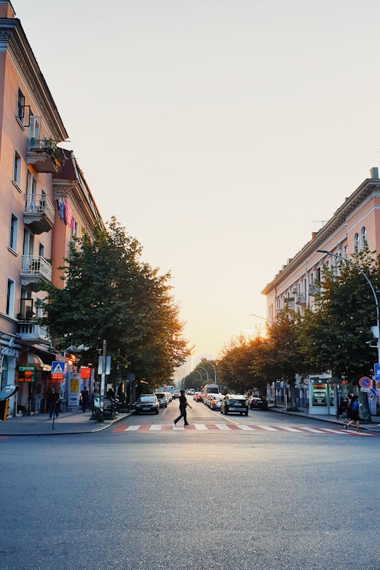 people walking on sidewalk near buildings during daytime in Batumi Georgia