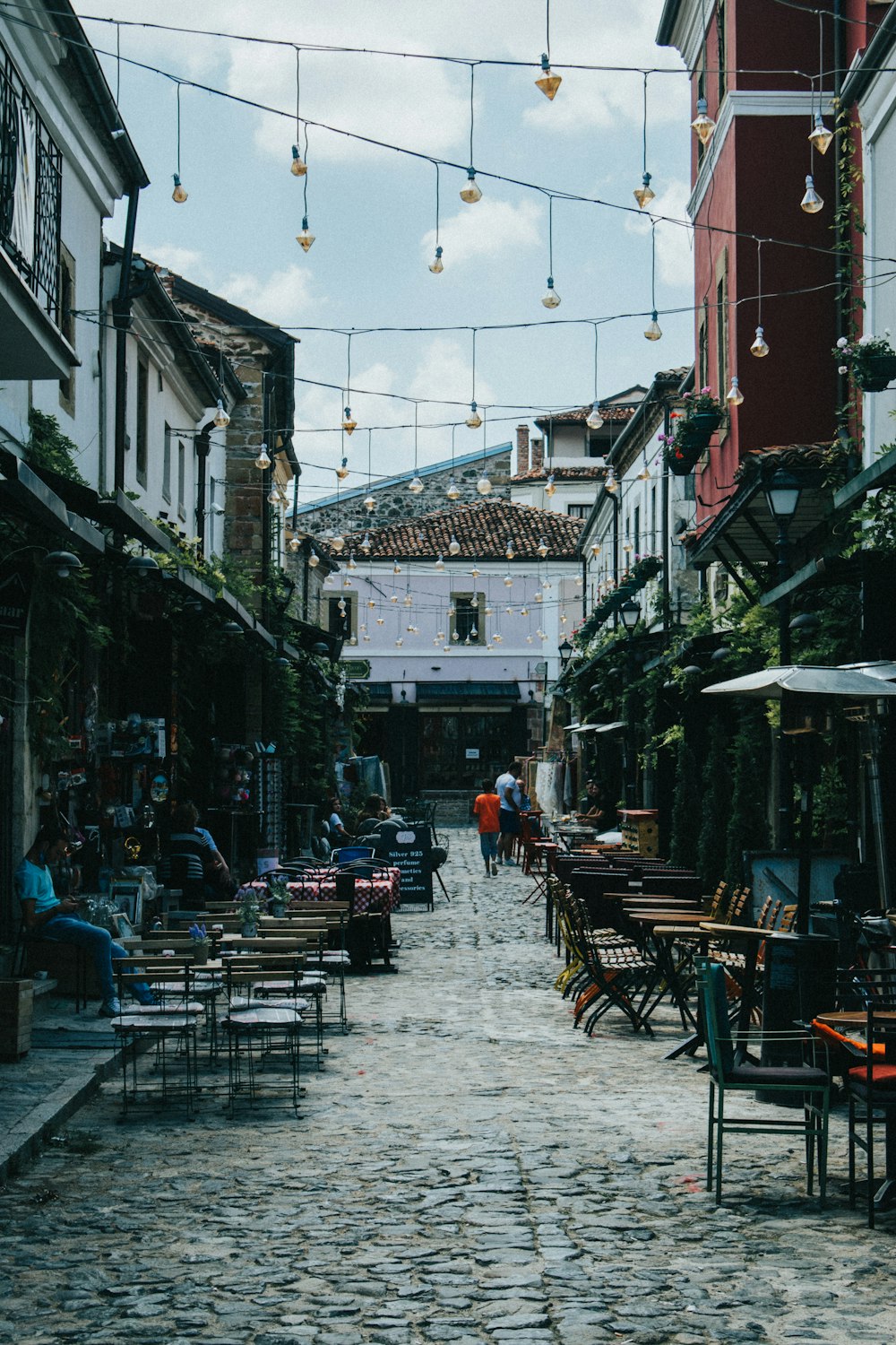 brown wooden table and chairs on street during daytime