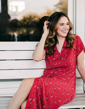 photography poses for women,how to photograph woman in red and white polka dot dress sitting on white wooden bench