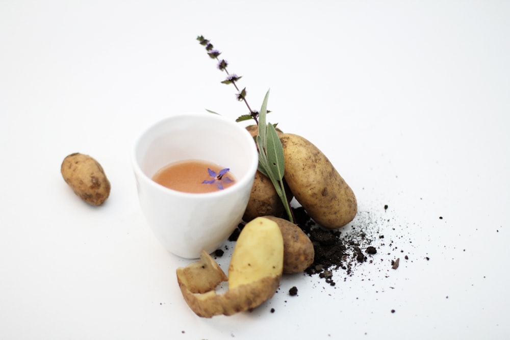 white ceramic cup with brown liquid